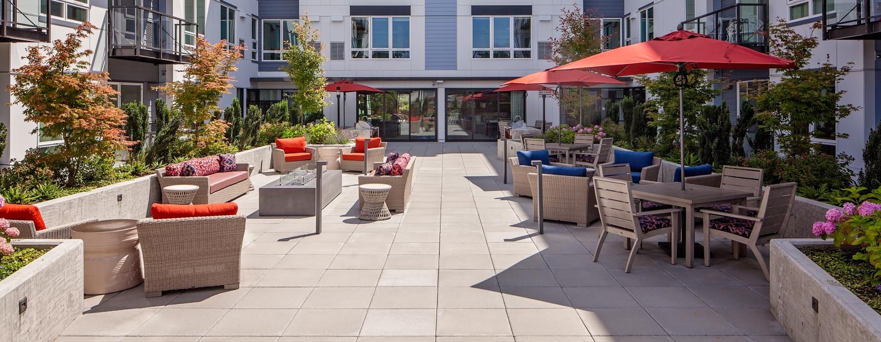 a patio with chairs and umbrellas