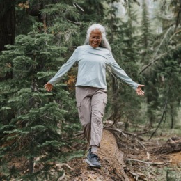 a woman walking on a log