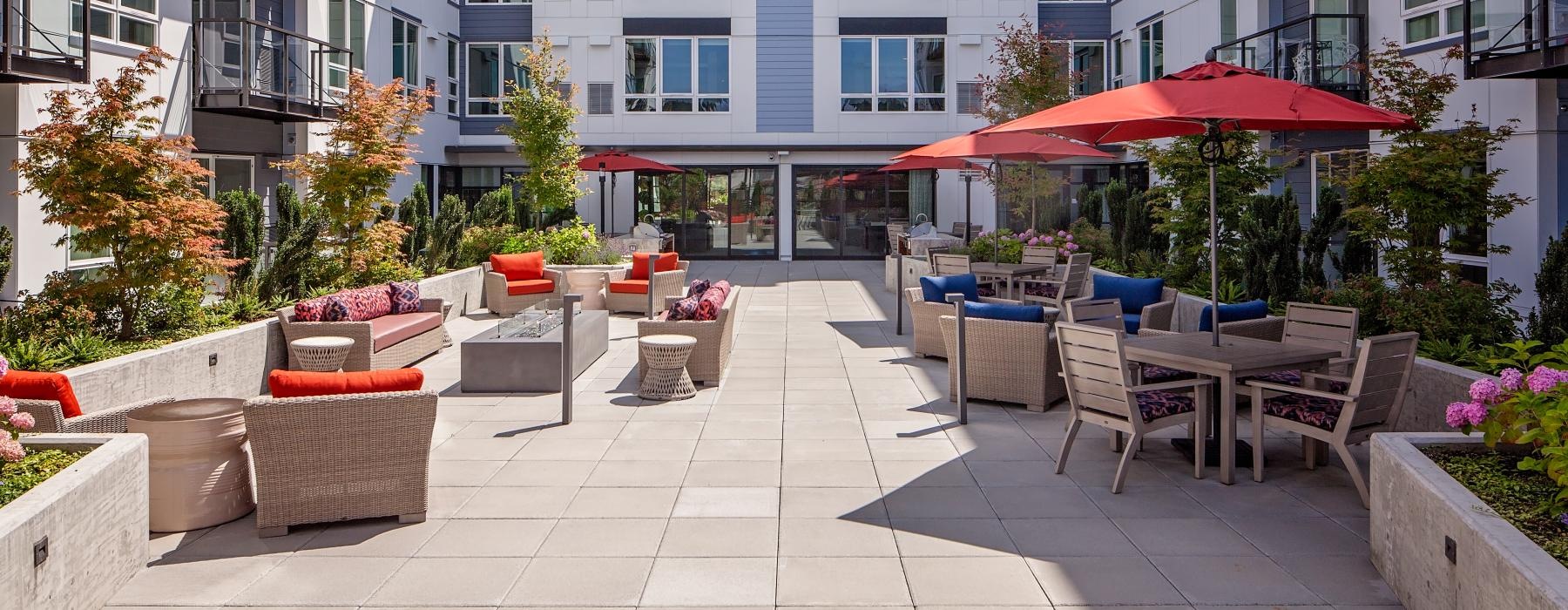 a patio with chairs and umbrellas