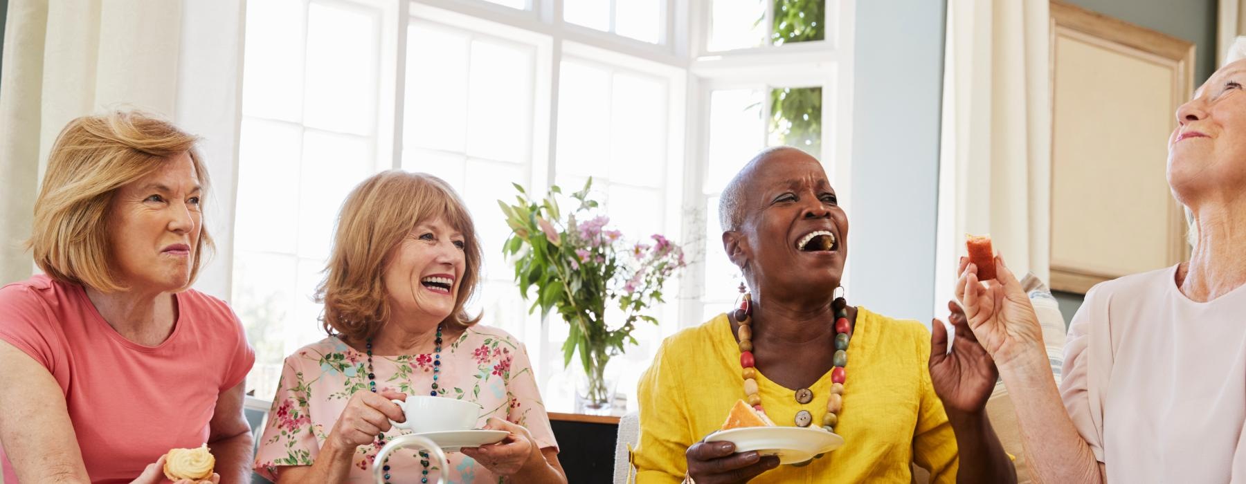 a group of people sitting around a table with food